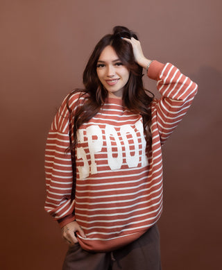 Close-up of soft cloudy knit fabric on Halloween striped top