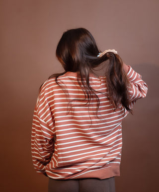 Side view of Halloween striped knit top with round neck