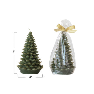Styled view of unscented evergreen tree-shaped candle with gold tips, 7 inches tall