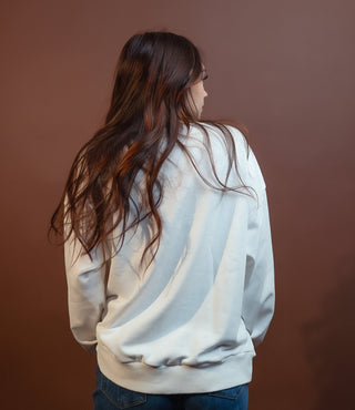 Friday Lights pullover styled on model with high-waisted jeans