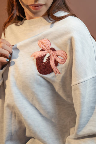 Back view of gray women's pullover with pink touchdown embroidery