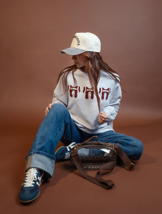 Close-up of arched Football puff embroidery on the cap front