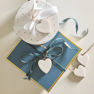 Set of enameled mango wood heart ornaments with jute string loops